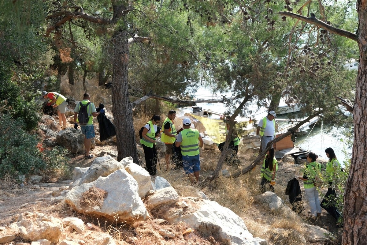 Muğla'nın Fethiye ilçesinde, karadan araçla ulaşımı olmayan deniz kenarında yapılan temizlikte 50...